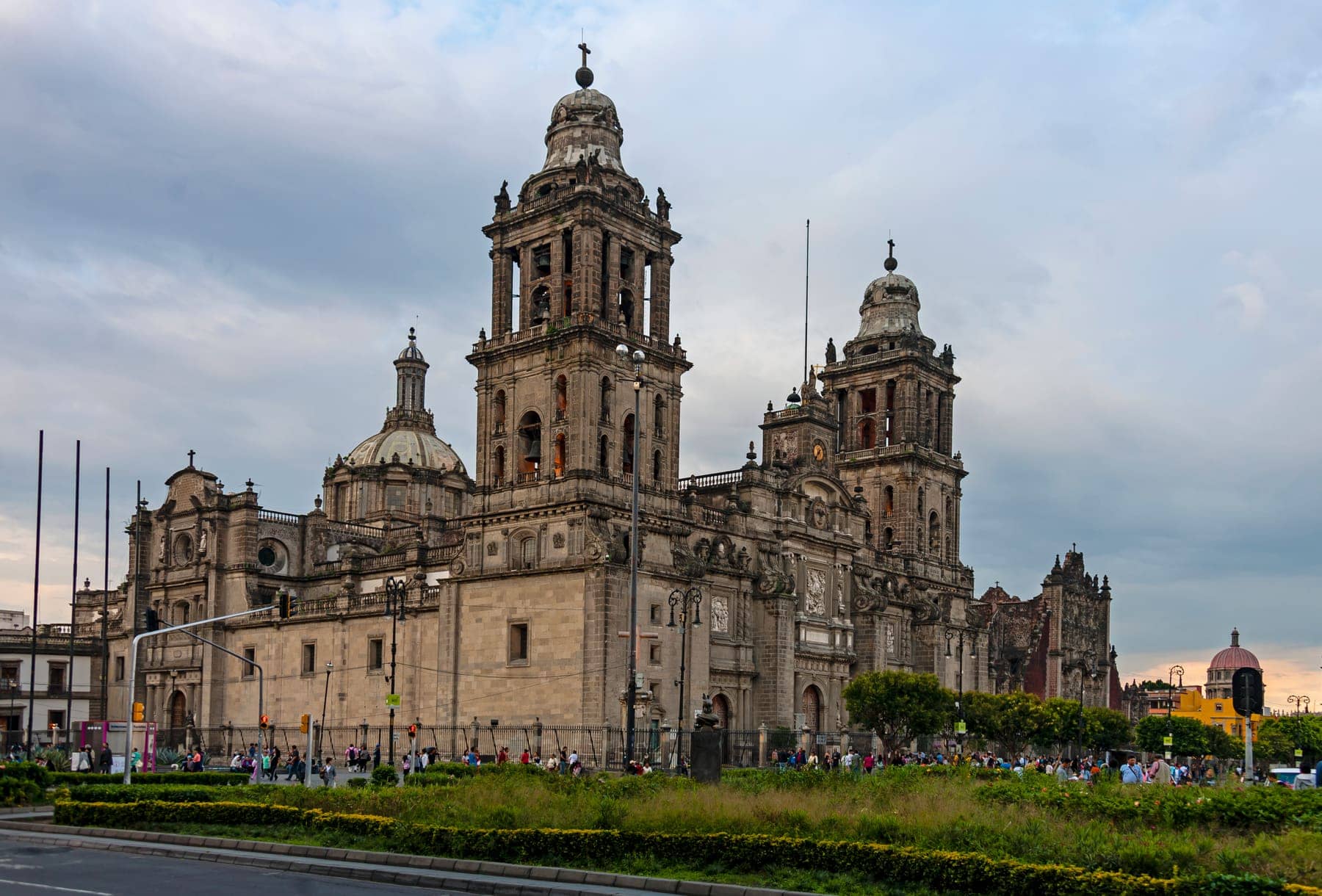 The baroque towers and facade of the Metropolitan Cathedral on the Zócalo in Mexico City under a cloudy sky